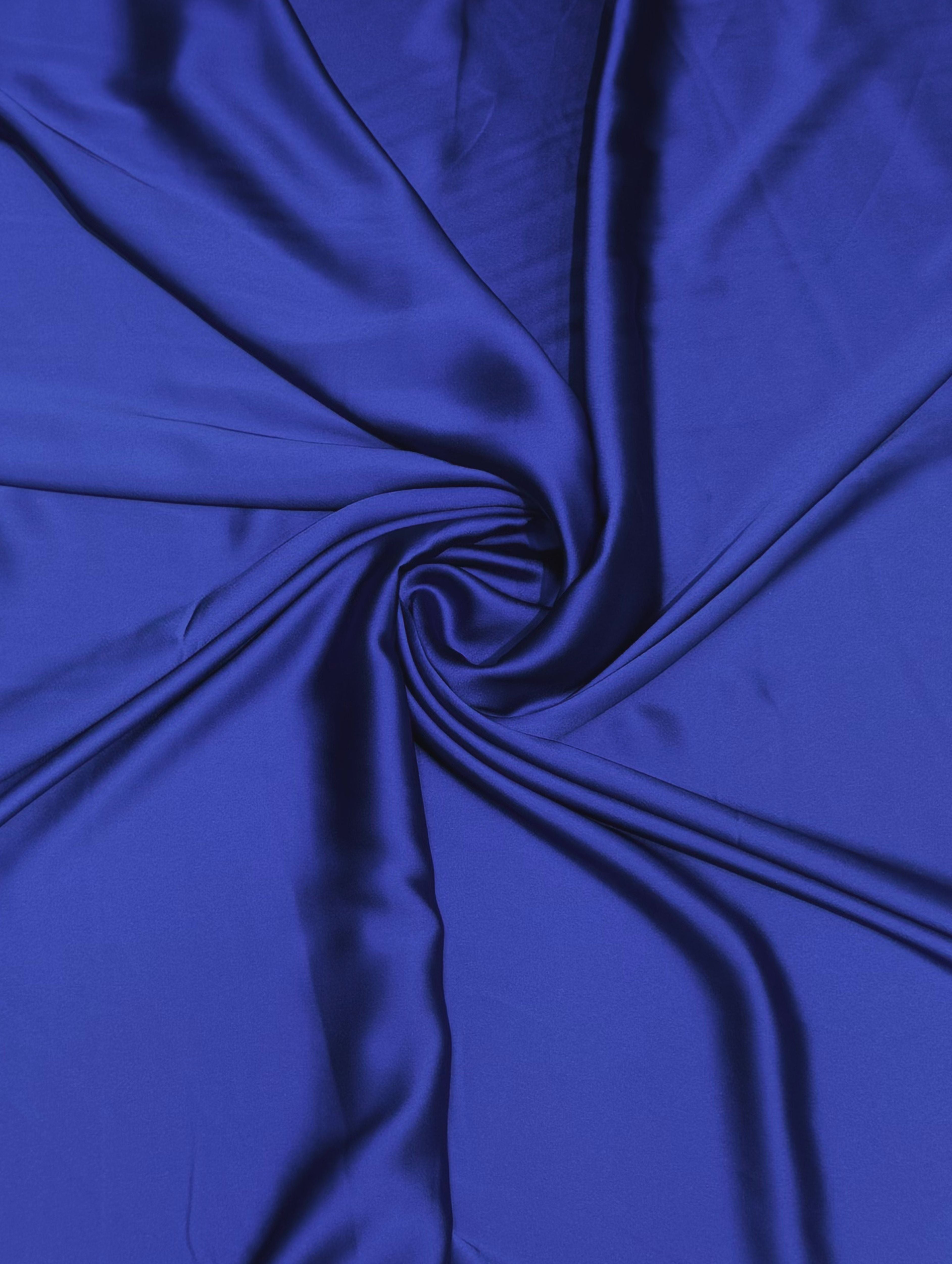Koningsblauwe crêpe satijn stof met luxe zijdeglans en soepelvallende kwaliteit, geschikt voor caftans, takshita's en exclusieve kledingstukken.