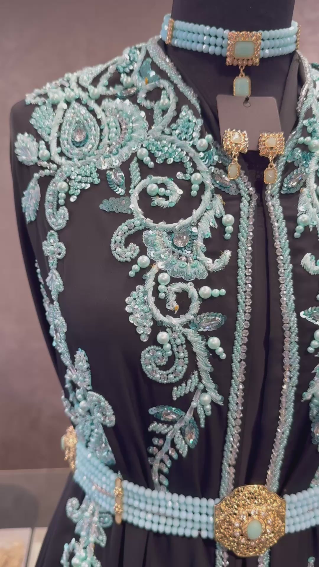 Video van zwarte takshita stof van crepe kwaliteit, bewerkt met lichtblauwe kralen en parels. De onderstof is zwarte crepe.